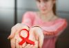 HIV & AIDS in Children – Causes, Symptoms & Treatment Child holding red ribbon