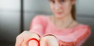 HIV & AIDS in Children – Causes, Symptoms & Treatment Child holding red ribbon