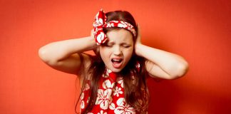 Psychosis (Schizophrenia) in Children – Information for Parents Little girl covering her ears, looking troubled