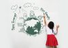 25 Must Know Planet Earth Facts for Kids A little girl drawing a creative of the Earth on a wall