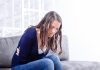 Top 10 Causes of Miscarriage A young woman holding her stomach in pain