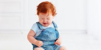 Strawberries for Babies – Health Benefits and Risks A kid looking at strawberry