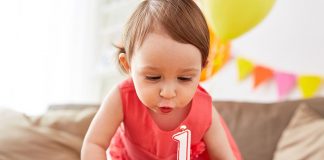 Your 12 Months Old Baby Growth and Development A one year-old girl blowing off her birthday candle