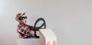 10 Creative Cardboard Crafts for Kids A little boy sitting inside a cardboard car