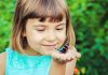 Interesting Butterfly Facts and Information for Kids A little girl with a butterfly resting on her palm