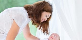 How To Get Baby To Sleep in Crib – 6 Effective Ways Mother putting the baby in a crib