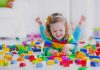 10 Interesting Colour Activities for Preschoolers Preschooler playing with colourful blocks