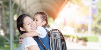 How to Prepare Your Child for School – Top 10 Tips A school girl in her mother's arms