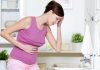 How Stress during Pregnancy Causes Miscarriage A woman feeling a stomach ache